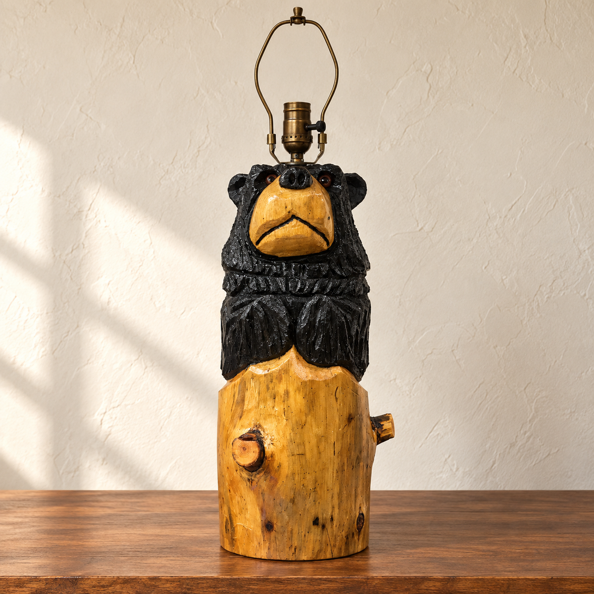 Handmade wooden bear emerging from a carved stump lamp base