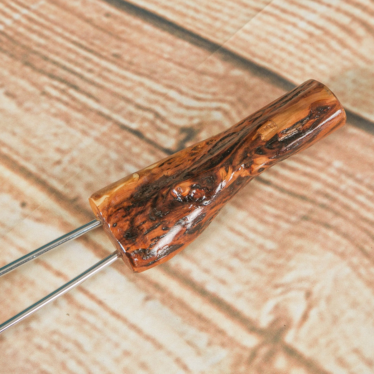Close-up of the natural Diamond Willow handle on a campfire roasting fork