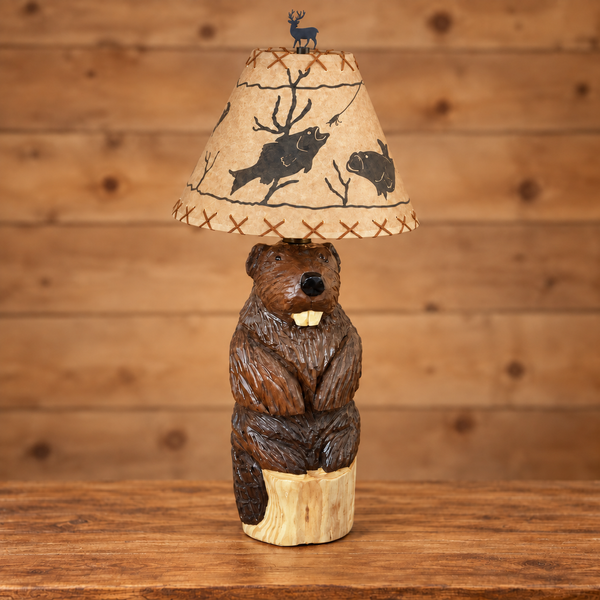 Handmade wooden beaver table lamp shown unlit with a tan woodland wildlife shade and deer finial